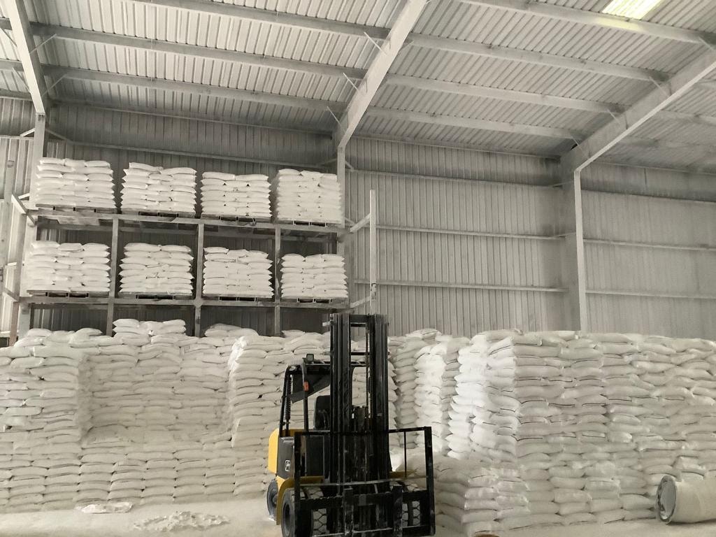 SK Stardust finished goods warehouse — stacked mineral bags and forklift dispatch